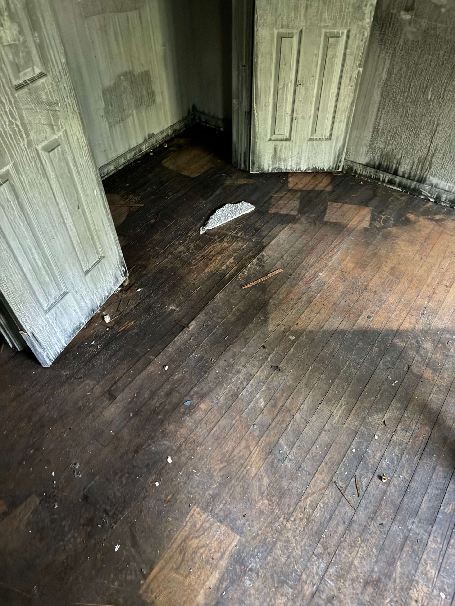 Fire damaged hardwood flooring restoration in Kansas City - professional fire damage cleanup and floor repair services
