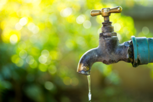 Brass,Water,Tap,In,Nature,Background.