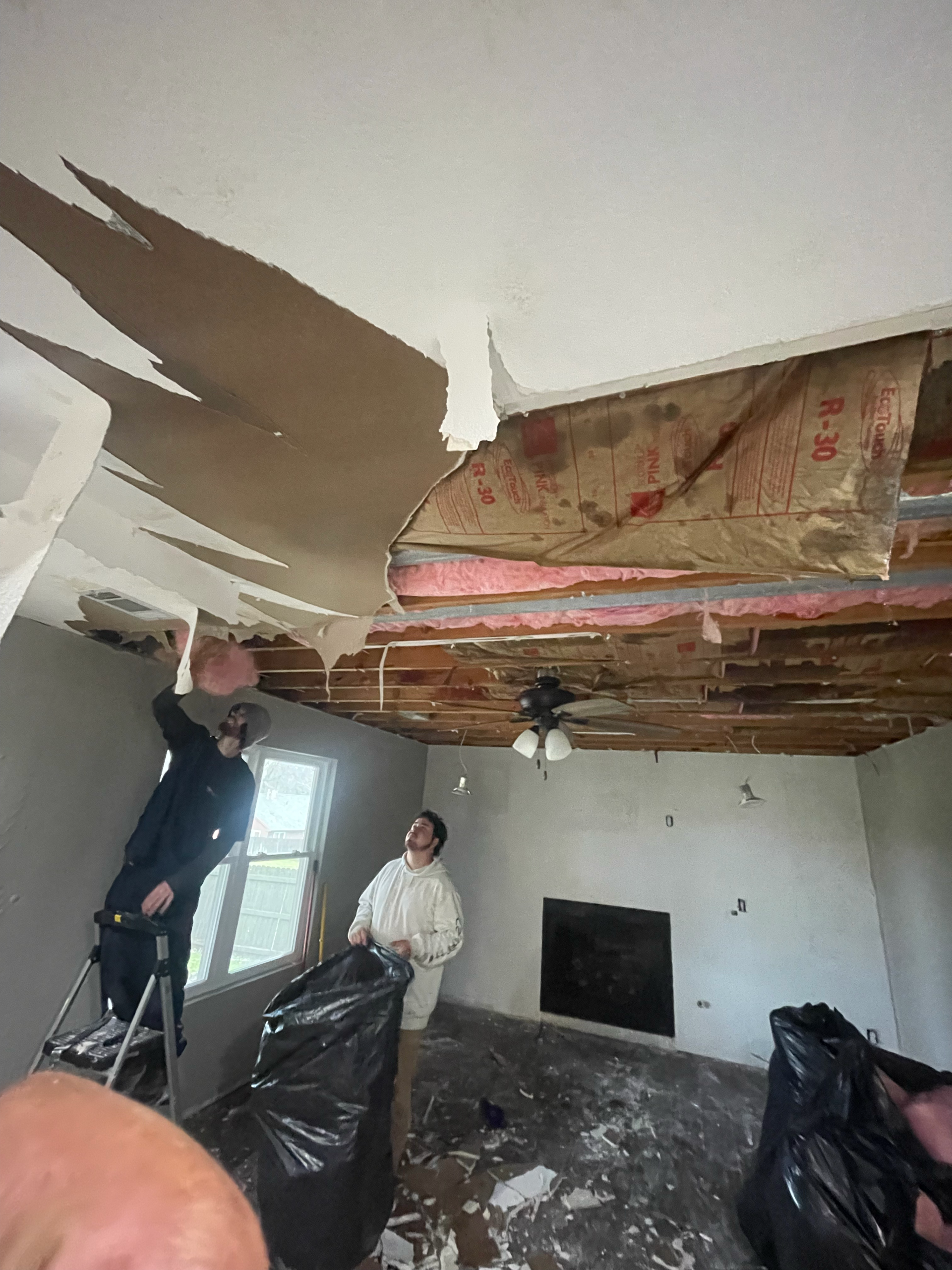 Restor KC crew removing a water-damaged ceiling in a Kansas City home