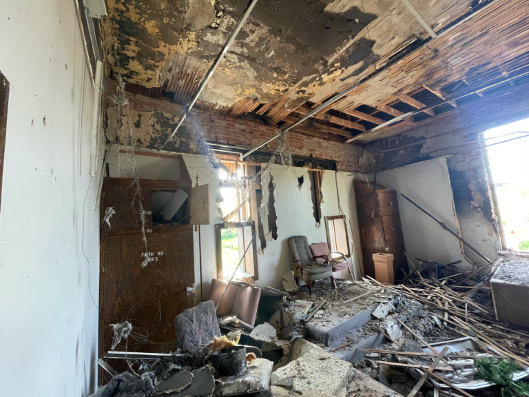 Fire-damaged room with collapsed ceiling and debris before Restor KC fire restoration