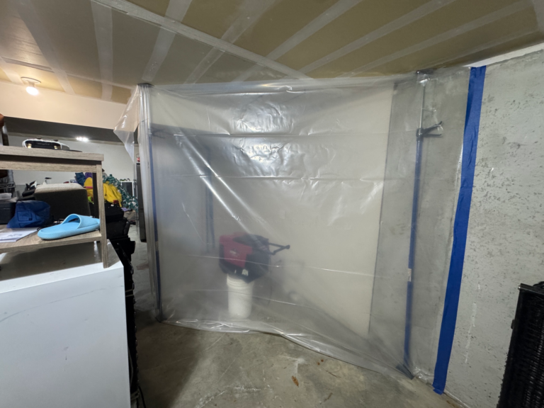 Sealed plastic mold containment with air filtration equipment inside a Kansas City basement