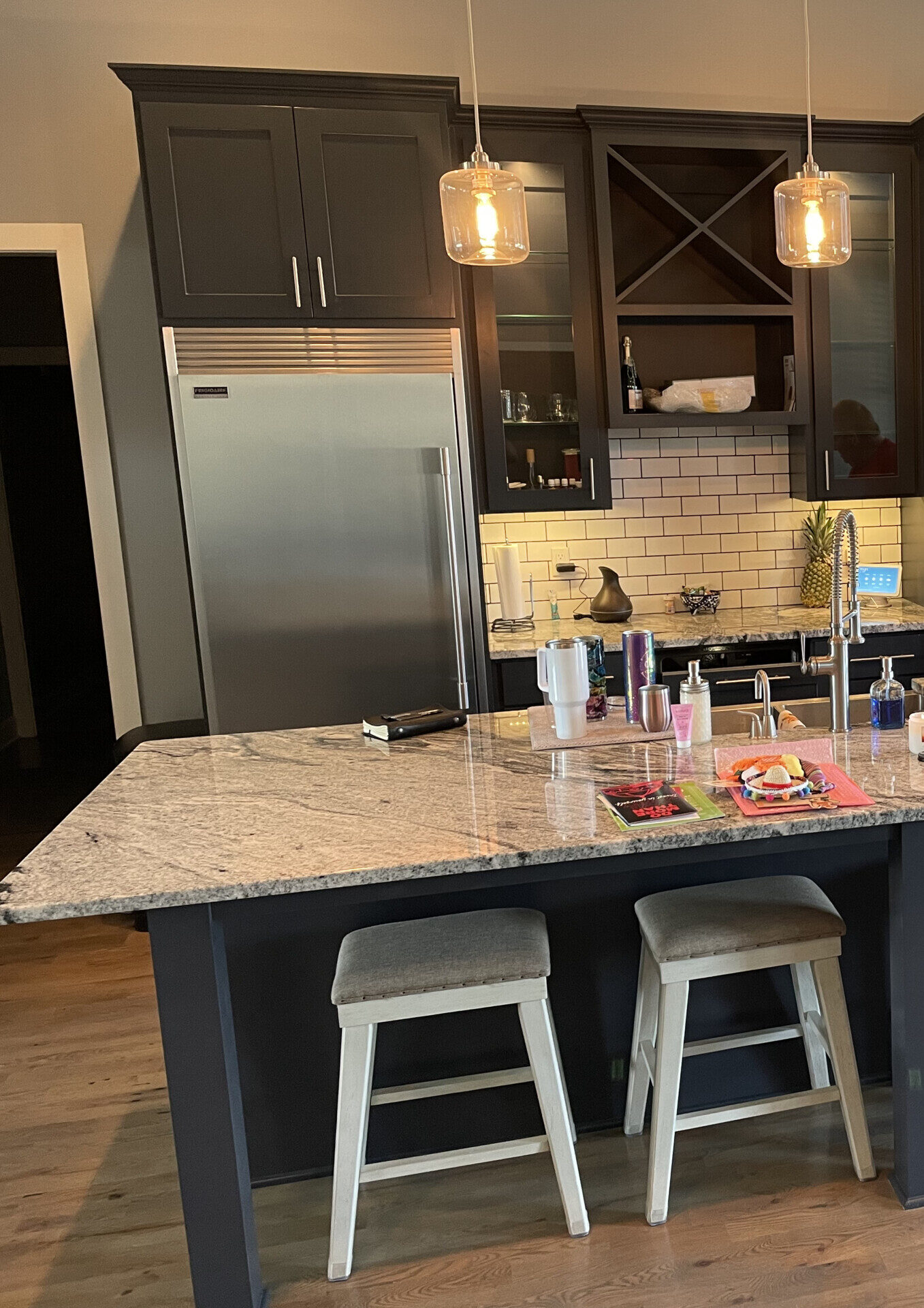 Kitchen remodel with navy cabinets, granite island and subway tile backsplash by Restor KC